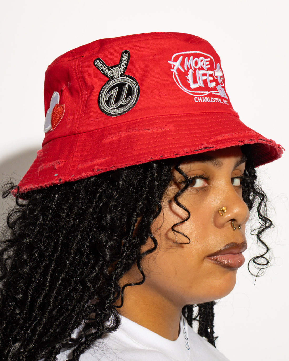 More Life CLT R&B Patchwork Distressed Bucket Hat Red – back view showing luxury watch patch and red glitter heart patch with More Life brim embroidery
