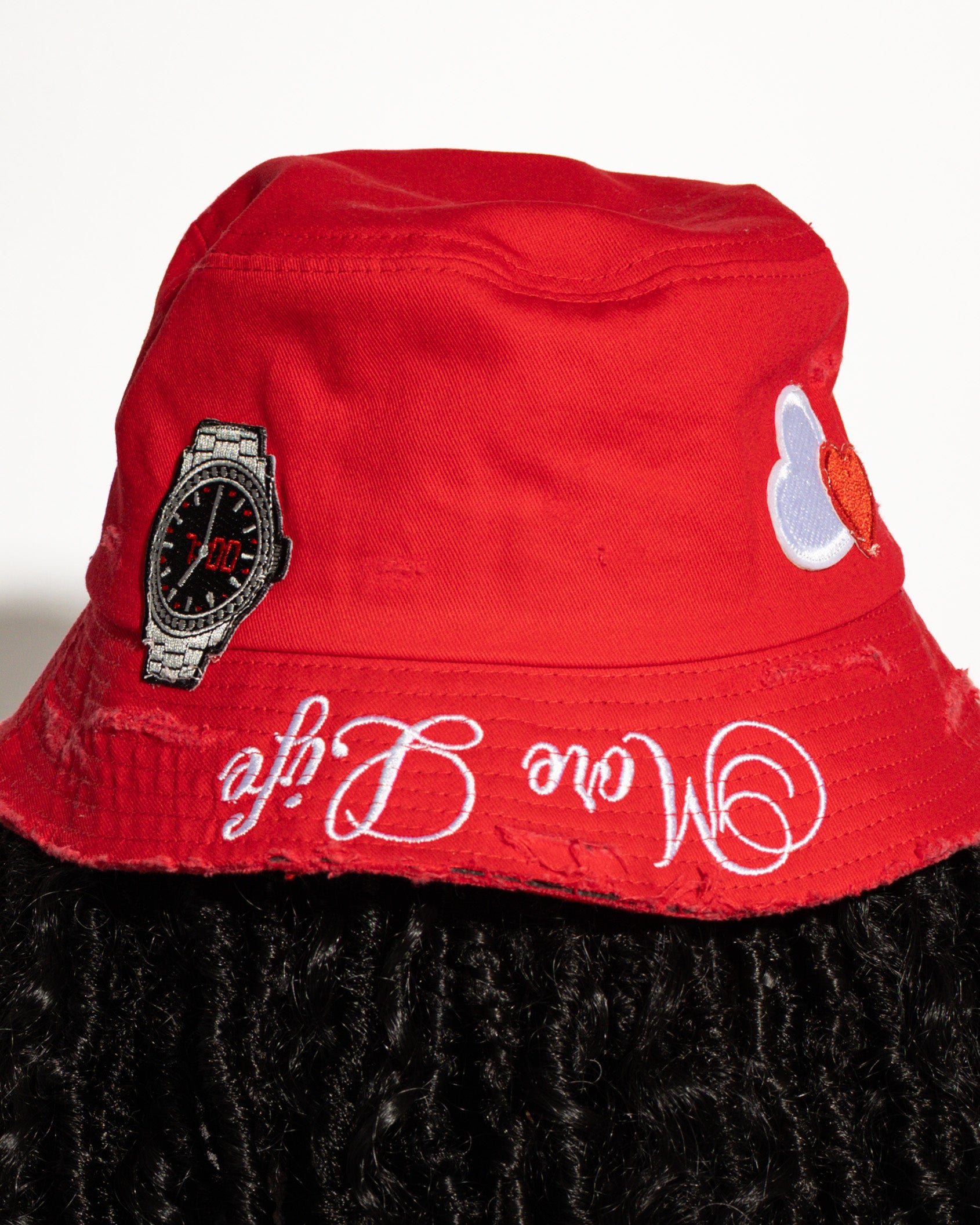More Life CLT R&B Patchwork Distressed Bucket Hat Red – side view showing purple daisy flower patch and More Life Charlotte NC logo