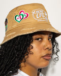 More Life CLT AKA Sorority Patchwork Distressed Bucket Hat Tan – side view on model showing AKA 1908 double heart patch and More Life Charlotte NC logo