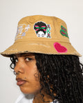 More Life CLT AKA Sorority Patchwork Distressed Bucket Hat Tan – side view on model showing AKA butterfly woman patch and pink heart on brim