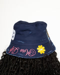 More Life CLT CB Breezy Bowl Stadium Tour Patchwork Distressed Bucket Hat Navy Blue – back view showing CB varsity letters patch yellow daisy flower and More Life pink brim embroidery