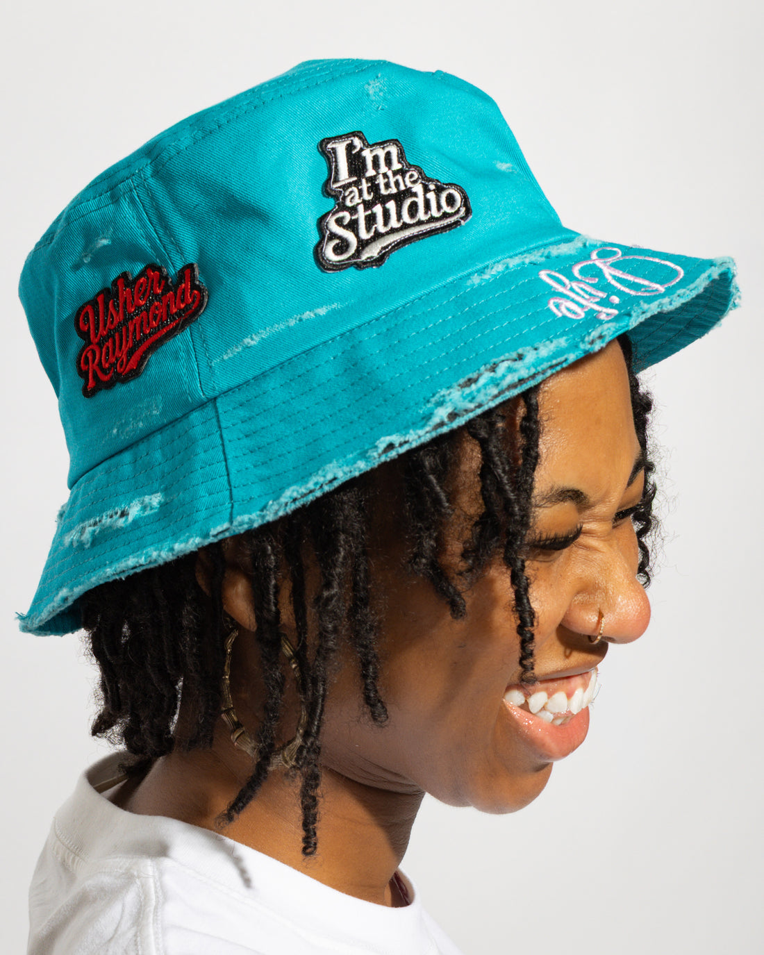 More Life CLT Usher Raymond ATL Patchwork Distressed Bucket Hat Teal – side view showing I'm at the Studio and Usher Raymond patches