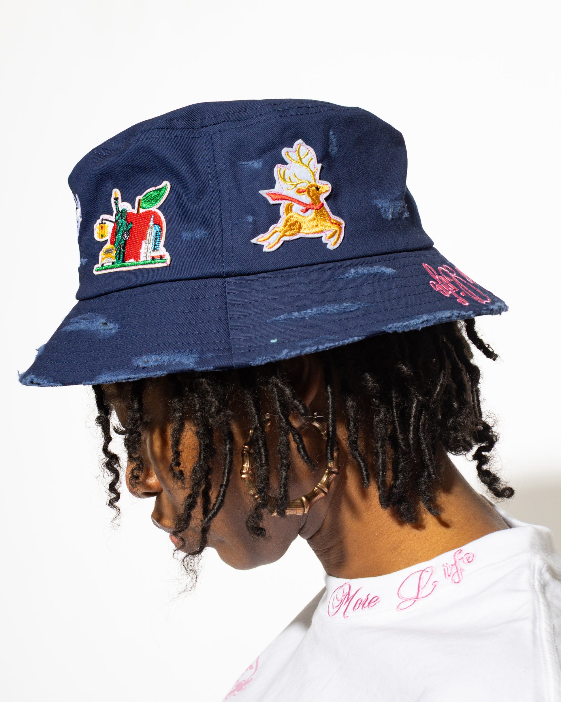 More Life CLT Charlotte Patchwork Distressed Bucket Hat Navy Blue – back view showing NYC skyline and flying reindeer patches