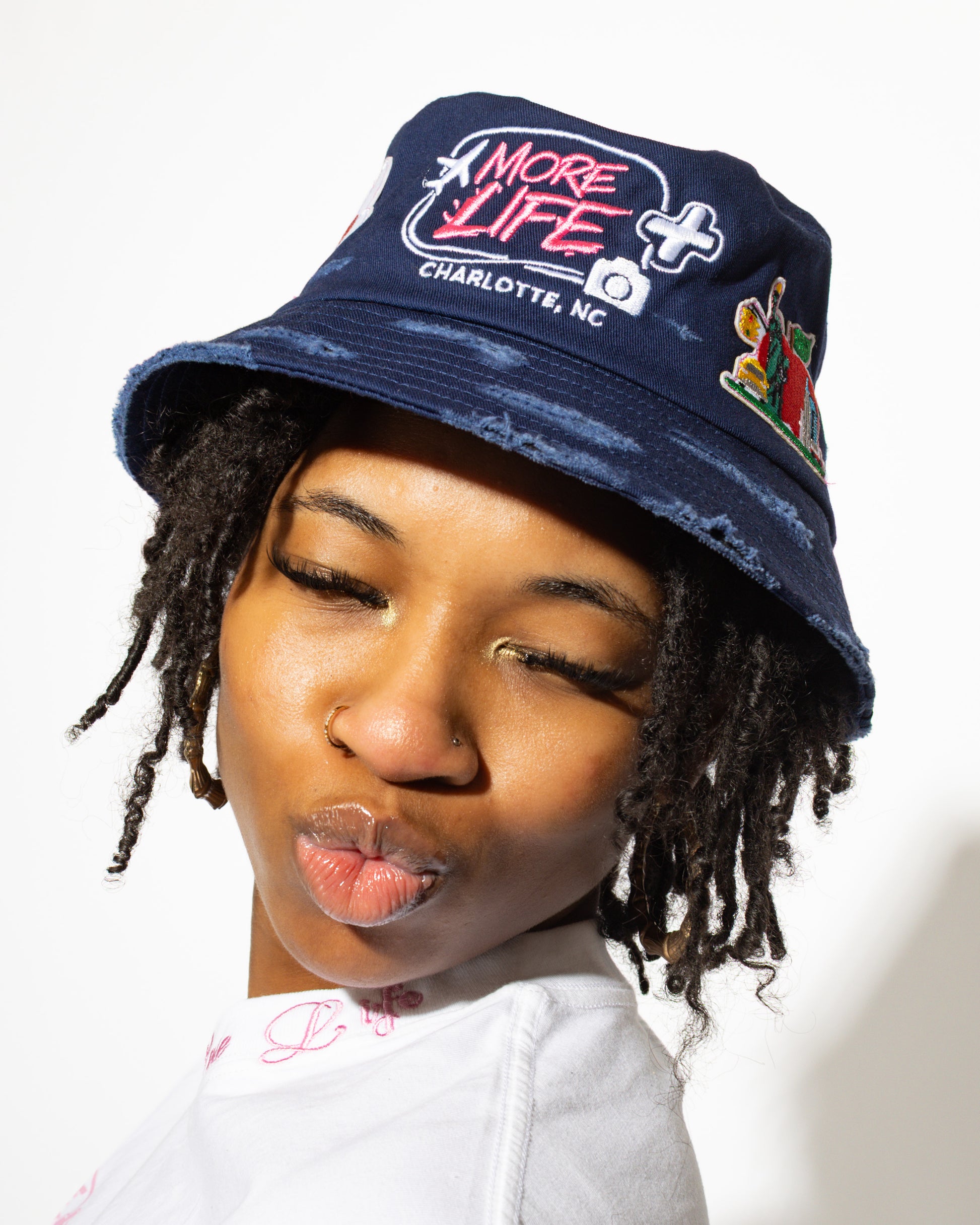 More Life CLT Charlotte Patchwork Distressed Bucket Hat Navy Blue – front view showing More Life Charlotte NC logo and African flag patch
