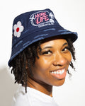 More Life CLT Charlotte Patchwork Distressed Bucket Hat Navy Blue – side view showing More Life Charlotte NC logo and daisy flower patch