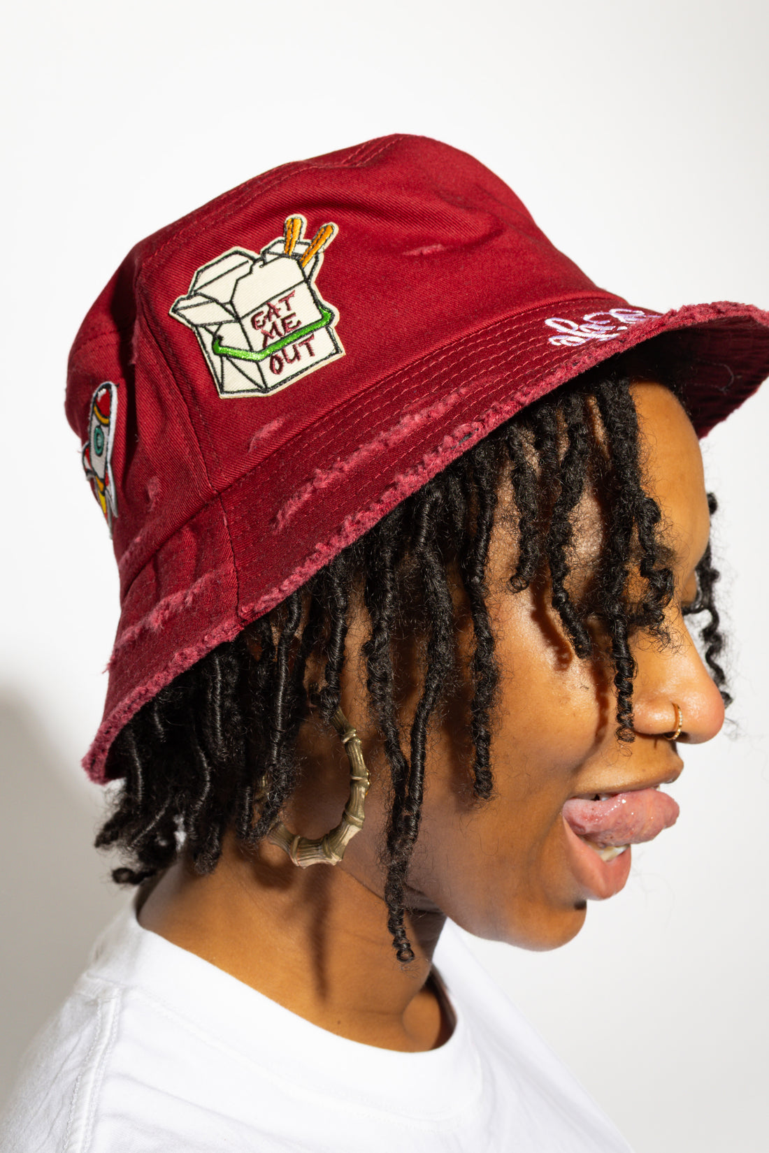 More Life CLT Eat Me Out Patchwork Distressed Bucket Hat Burgundy – side view showing Eat Me Out takeout box patch and More Life script
