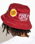 More Life CLT Eat Me Out Patchwork Distressed Bucket Hat Burgundy – back view showing More Life Charlotte NC logo and sunflower patch