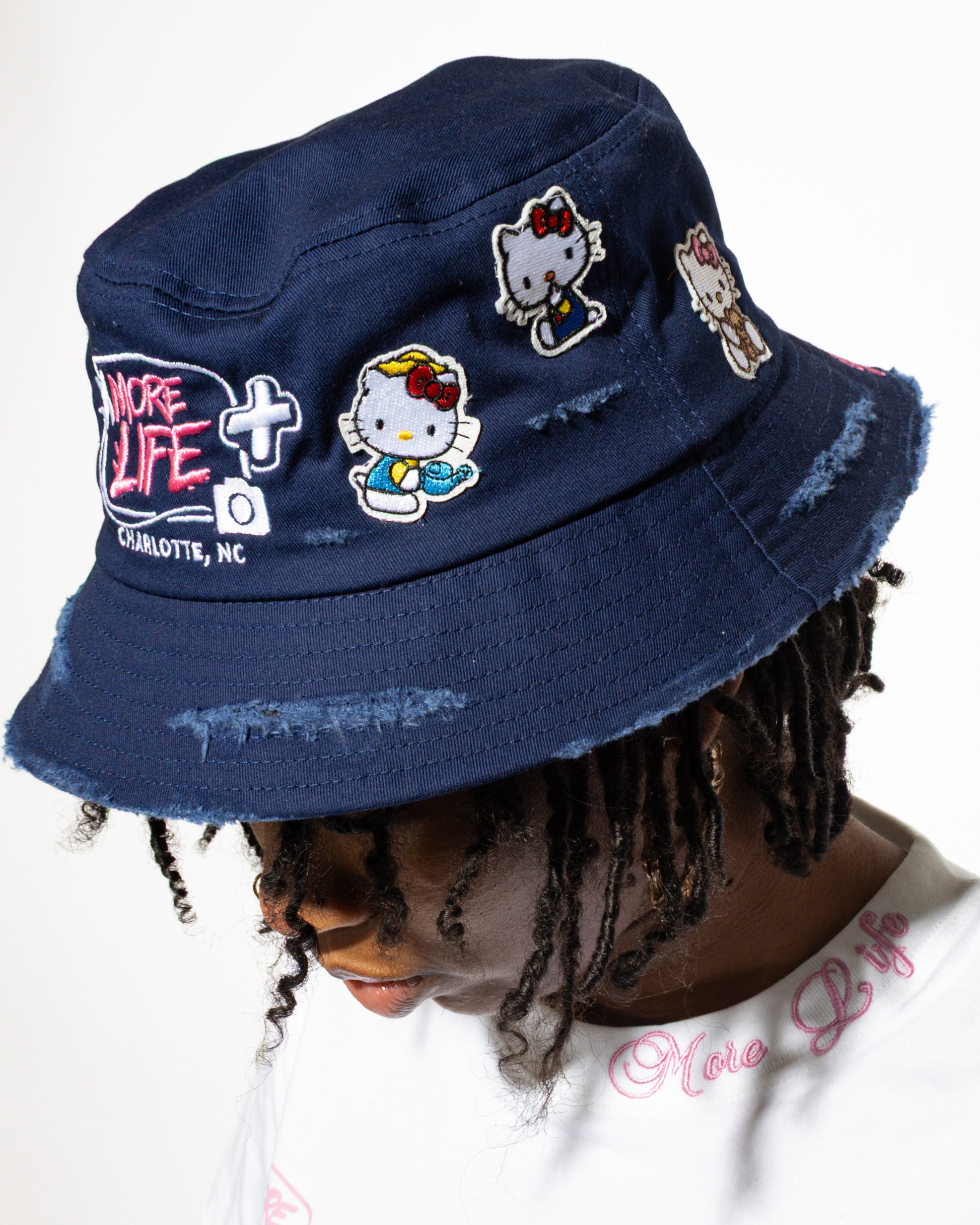 More Life CLT Hello Kitty Patchwork Distressed Bucket Hat Navy Blue – back view showing More Life Charlotte NC logo and Hello Kitty patches